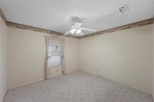 carpeted empty room featuring a textured ceiling and ceiling fan