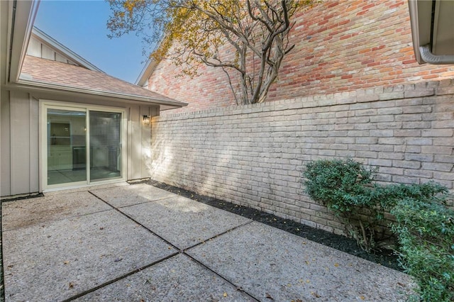 view of side of property with a patio area