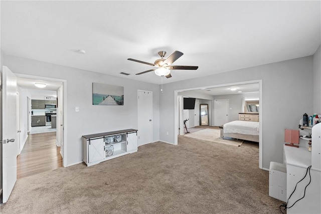 carpeted bedroom featuring ceiling fan