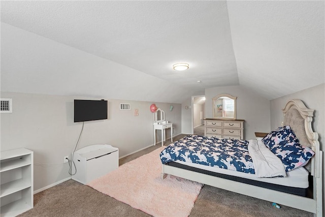 bedroom with carpet floors, vaulted ceiling, and a textured ceiling