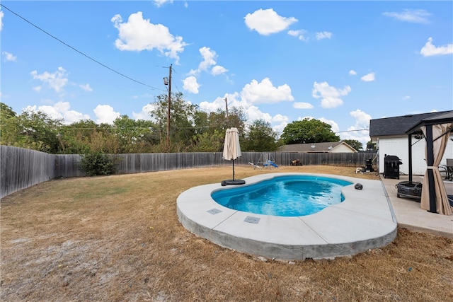 view of pool with a patio and a lawn