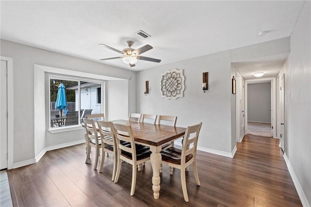 dining space featuring ceiling fan and dark hardwood / wood-style floors