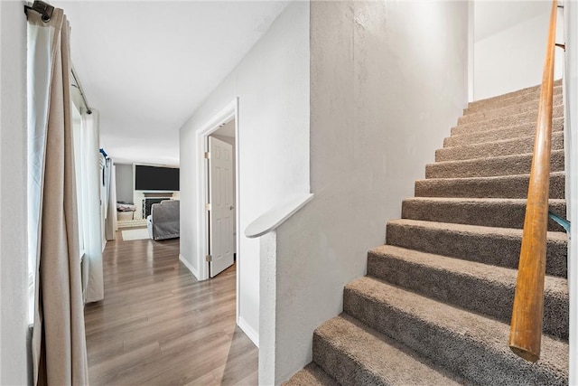 stairs with hardwood / wood-style flooring