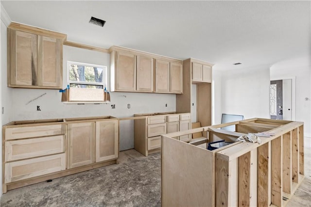 kitchen with crown molding, light brown cabinetry, and a center island