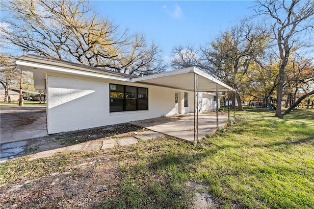 back of property featuring a lawn