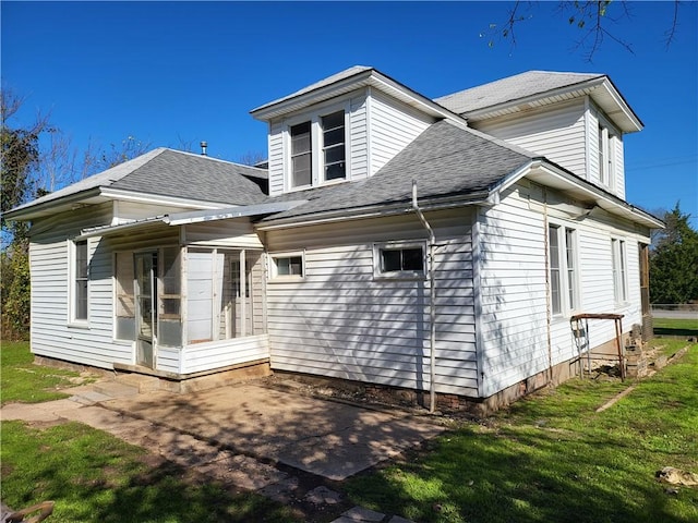 view of front of house with a patio and a front yard