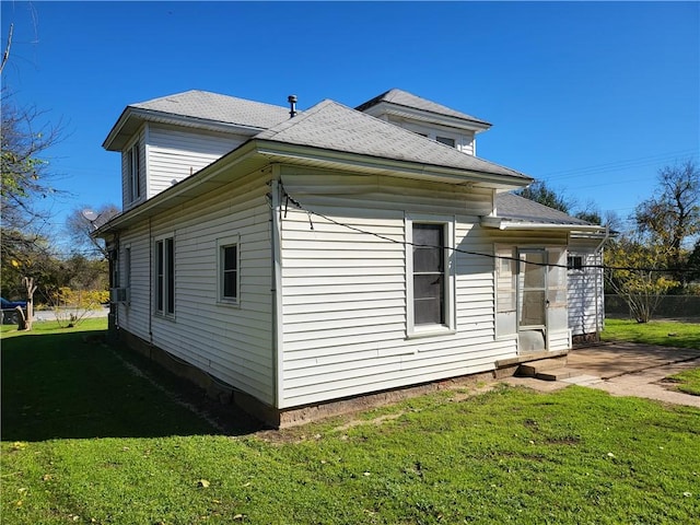 view of side of property featuring a yard