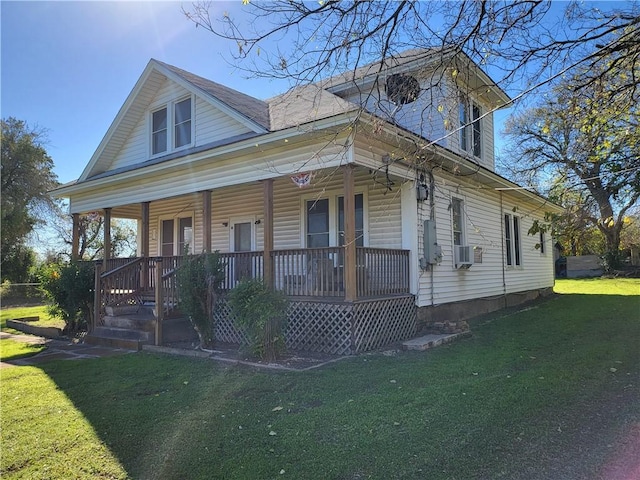 view of front facade featuring cooling unit, a front lawn, and covered porch