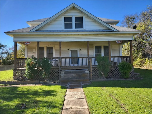 bungalow with covered porch and a front yard