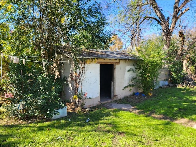 view of outdoor structure featuring a lawn