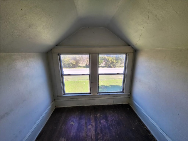 bonus room featuring dark hardwood / wood-style flooring and vaulted ceiling