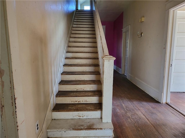 stairs featuring hardwood / wood-style floors