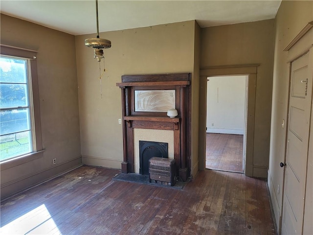 unfurnished living room with plenty of natural light and dark hardwood / wood-style floors