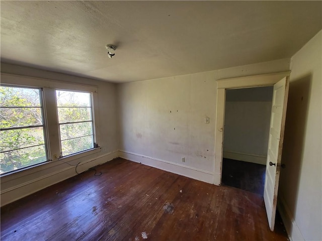 unfurnished room featuring dark hardwood / wood-style floors