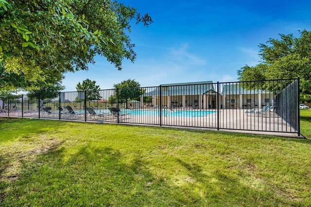 view of swimming pool featuring a yard and a patio