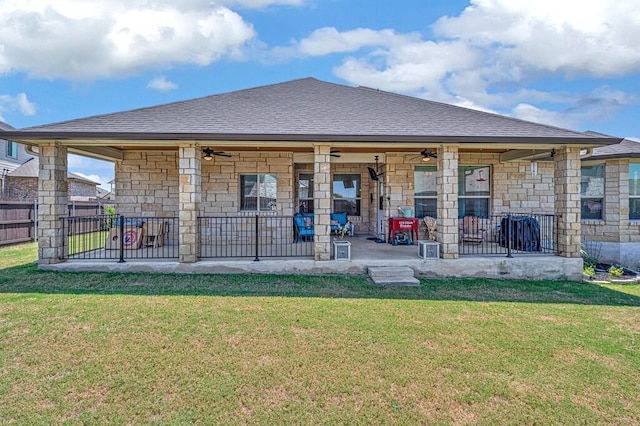 rear view of house featuring a patio, ceiling fan, and a lawn