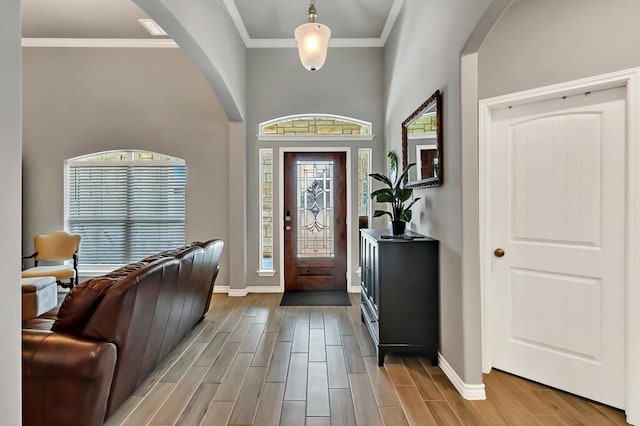 entrance foyer featuring light wood-type flooring and crown molding