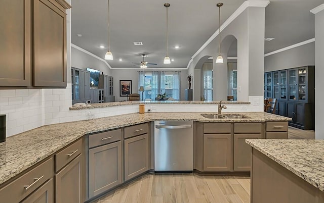 kitchen featuring light stone countertops, sink, light hardwood / wood-style flooring, stainless steel dishwasher, and ornamental molding