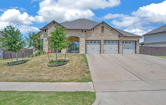 view of front of house with a garage and a front lawn