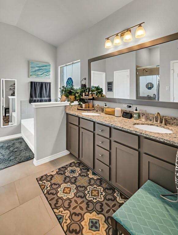 bathroom with tile patterned flooring, vanity, vaulted ceiling, and plus walk in shower