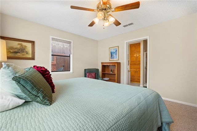 bedroom featuring a textured ceiling, carpet floors, and ceiling fan