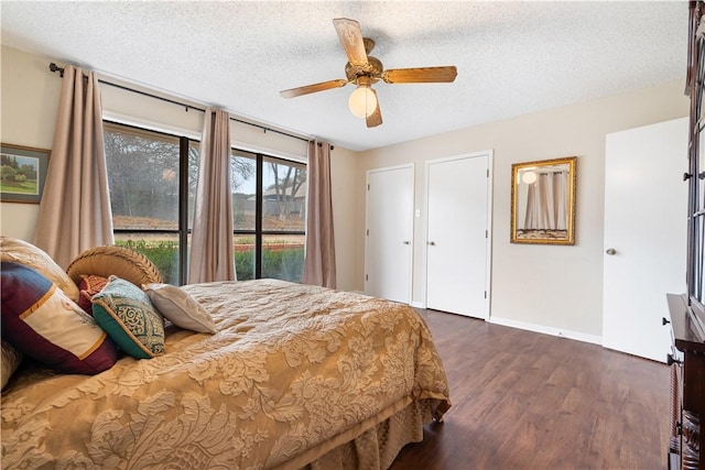 bedroom featuring ceiling fan, dark hardwood / wood-style floors, and a textured ceiling