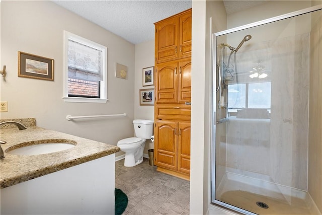 bathroom with walk in shower, vanity, toilet, and a textured ceiling