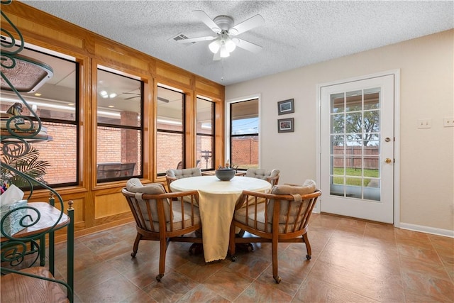 dining room featuring ceiling fan and a textured ceiling