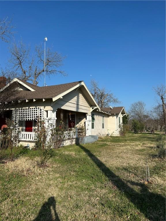 back of house with a lawn