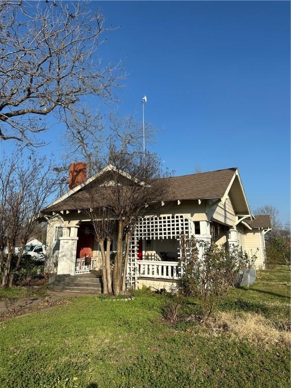 back of house with a lawn