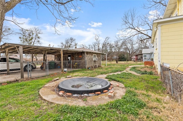 view of yard with a carport and fence