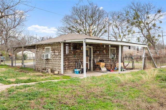 view of outdoor structure featuring a gate and fence