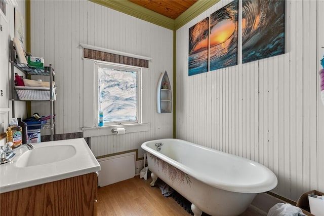 bathroom featuring vanity, a freestanding tub, and wood finished floors