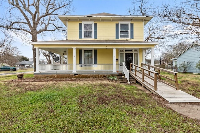 view of front of home with covered porch and a front yard