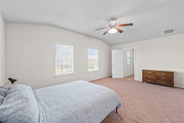 carpeted bedroom with ceiling fan and vaulted ceiling