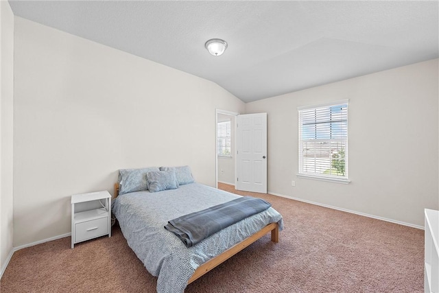 bedroom with carpet and lofted ceiling