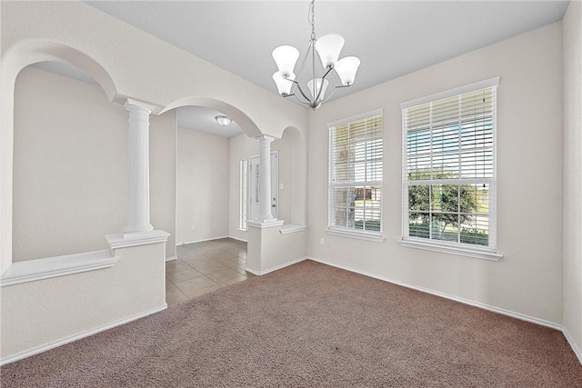 carpeted empty room featuring an inviting chandelier