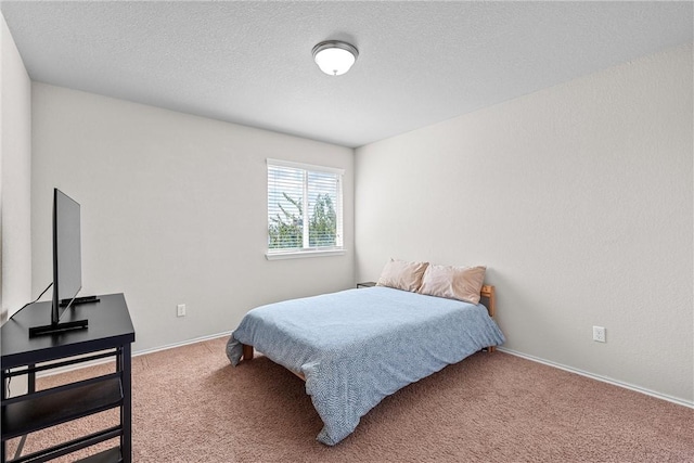 carpeted bedroom featuring a textured ceiling