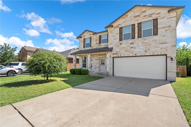 view of front of house with a front yard and a garage