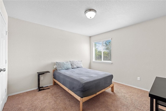 carpeted bedroom featuring a textured ceiling