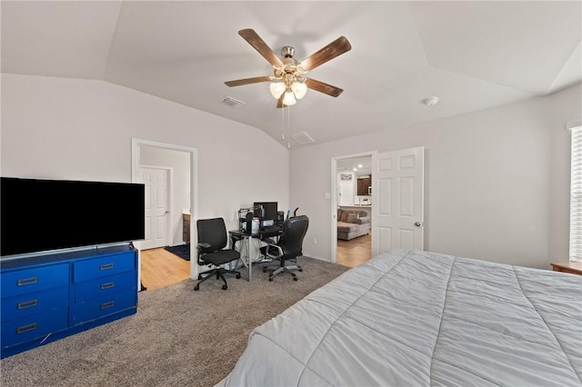 bedroom with vaulted ceiling, visible vents, carpet, and a ceiling fan