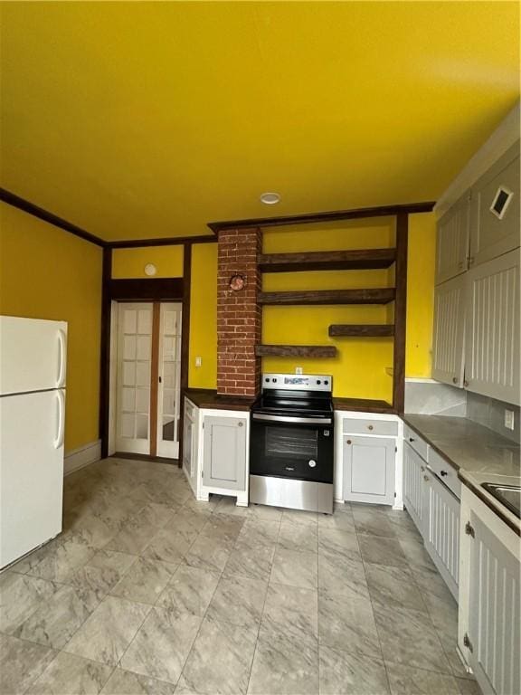 kitchen with sink, french doors, stainless steel range with electric cooktop, white fridge, and white cabinets