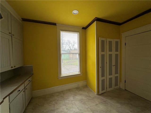 interior space with crown molding