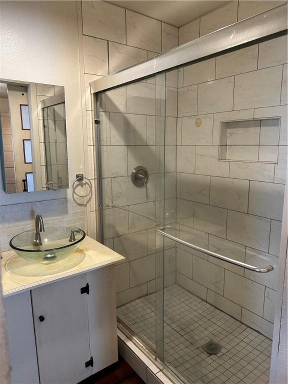 bathroom with vanity and an enclosed shower