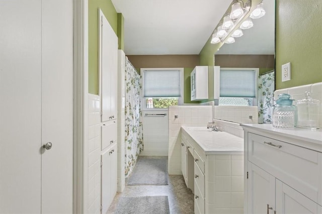 bathroom featuring vanity and tile walls