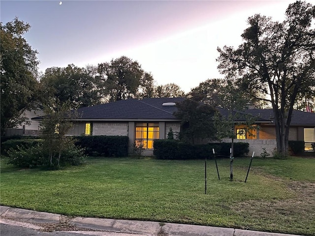 ranch-style house with a yard