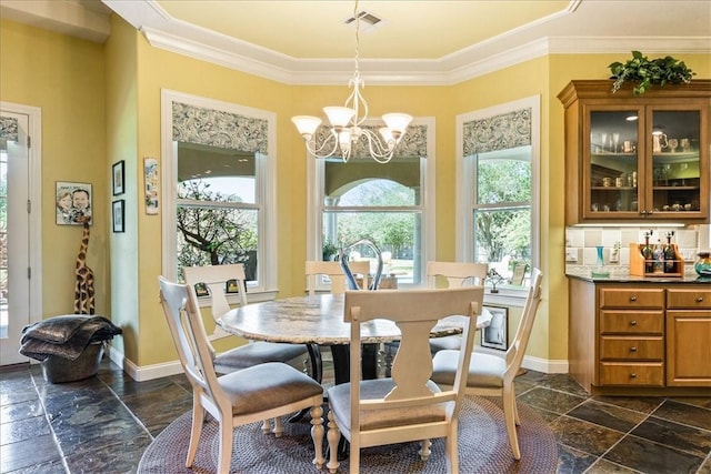 dining room featuring crown molding and a chandelier