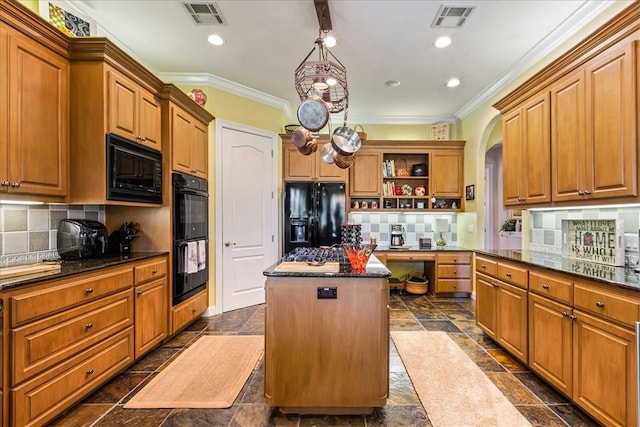 kitchen with tasteful backsplash, ornamental molding, a kitchen island, and black appliances