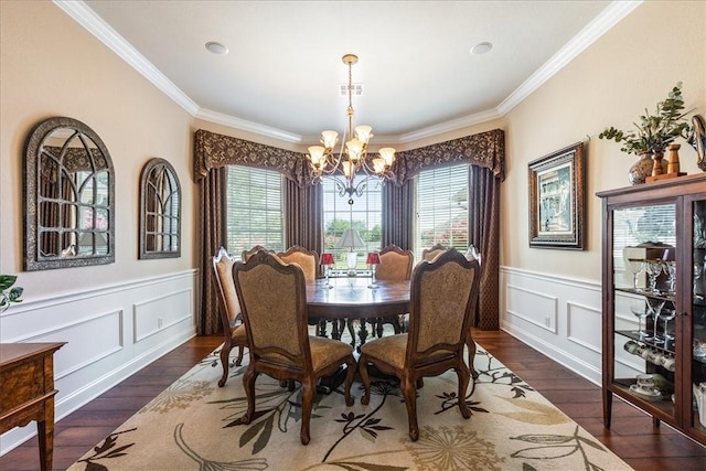 dining room with crown molding, dark wood-type flooring, and a chandelier