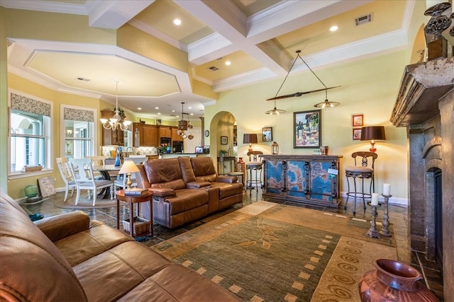 living area featuring visible vents, arched walkways, coffered ceiling, an inviting chandelier, and beam ceiling